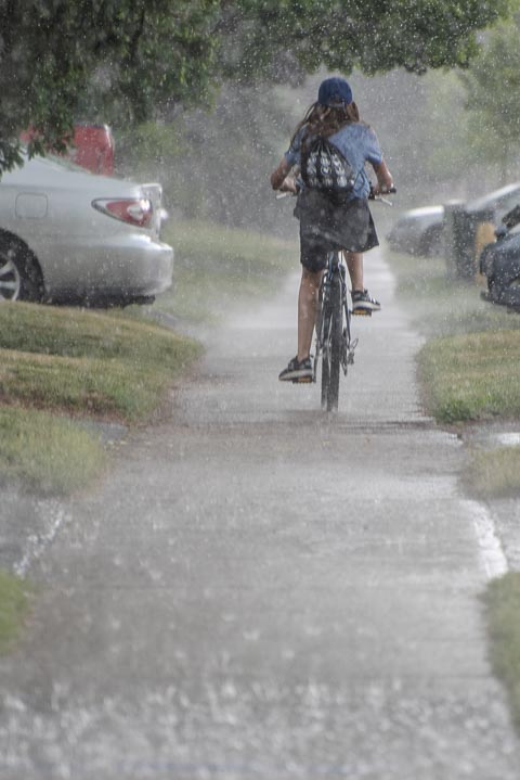a girl riding in the rain
